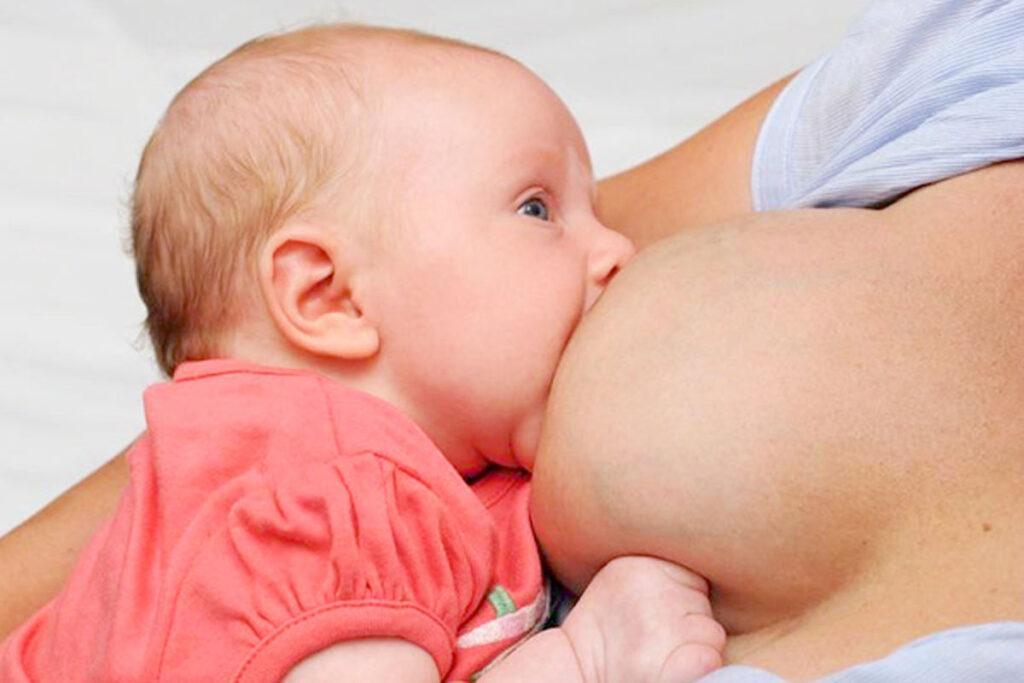 Baby with a wide jaw latched on well to the breast