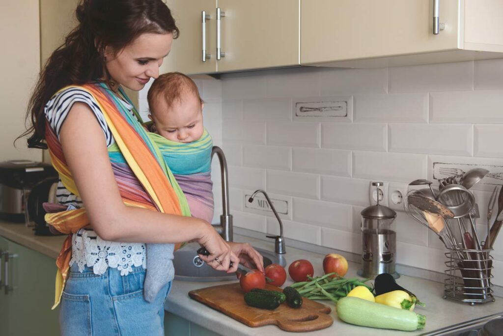 Mother cooking at home following a dairy-free breastfeeding diet