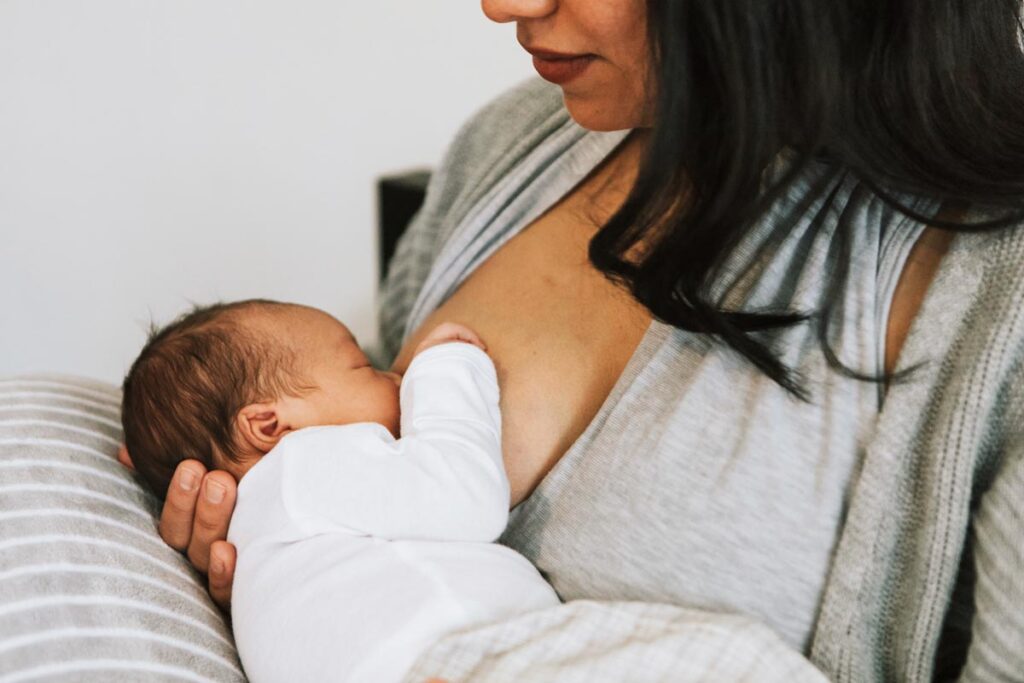 If your pediatrician suggests that baby is using you as a pacifier, you may not have a breastfeeding friendly pediatrician. Mother breastfeeding her young baby on a nursing pillow.