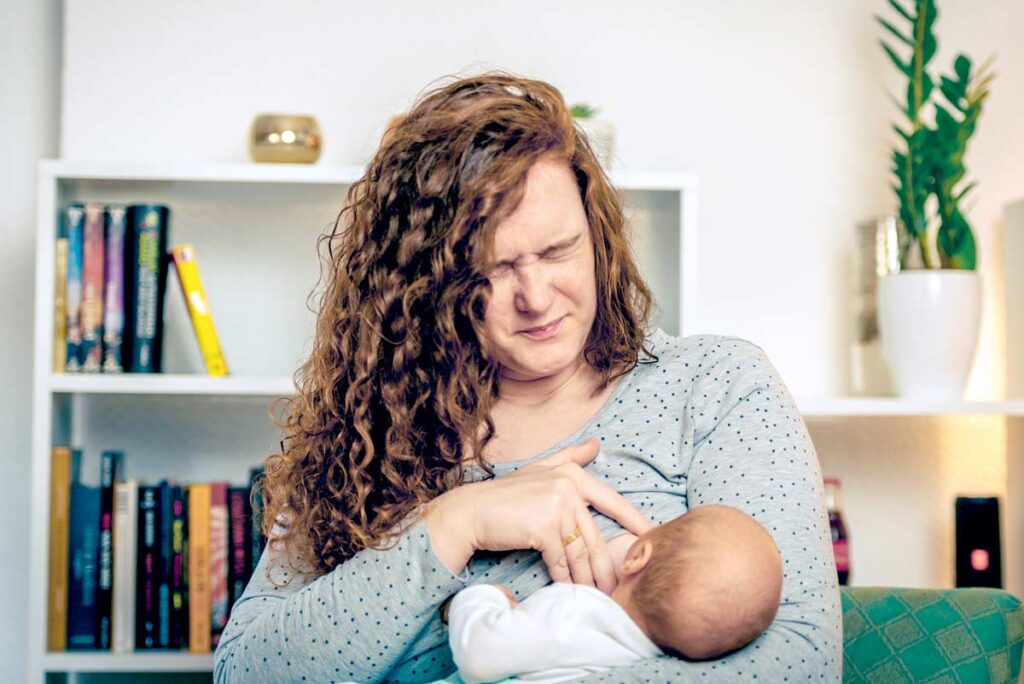 Breastfeeding parent experiencing nipple soreness